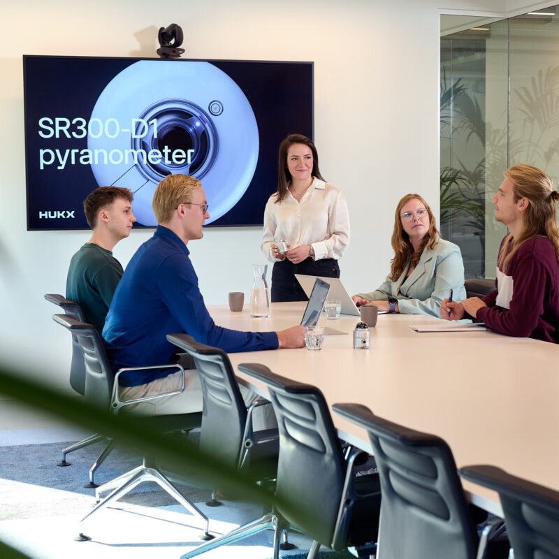 Hukx employees meeting in office setting